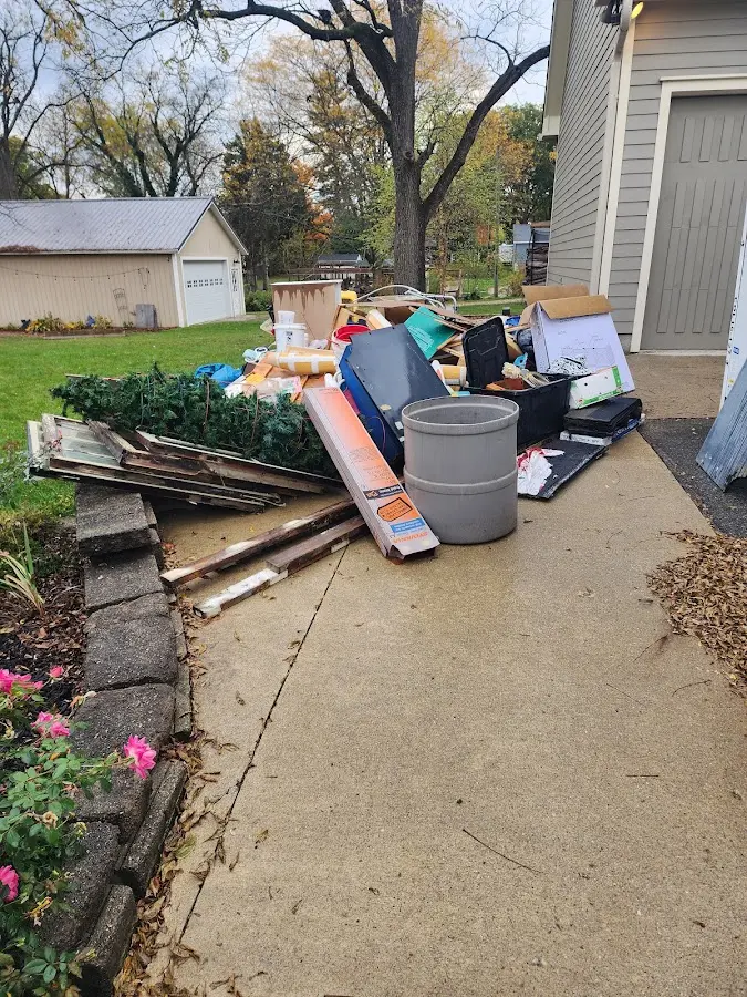 Dumpster being loaded with debris for Roofing Dumpster Rental in Eagle Point